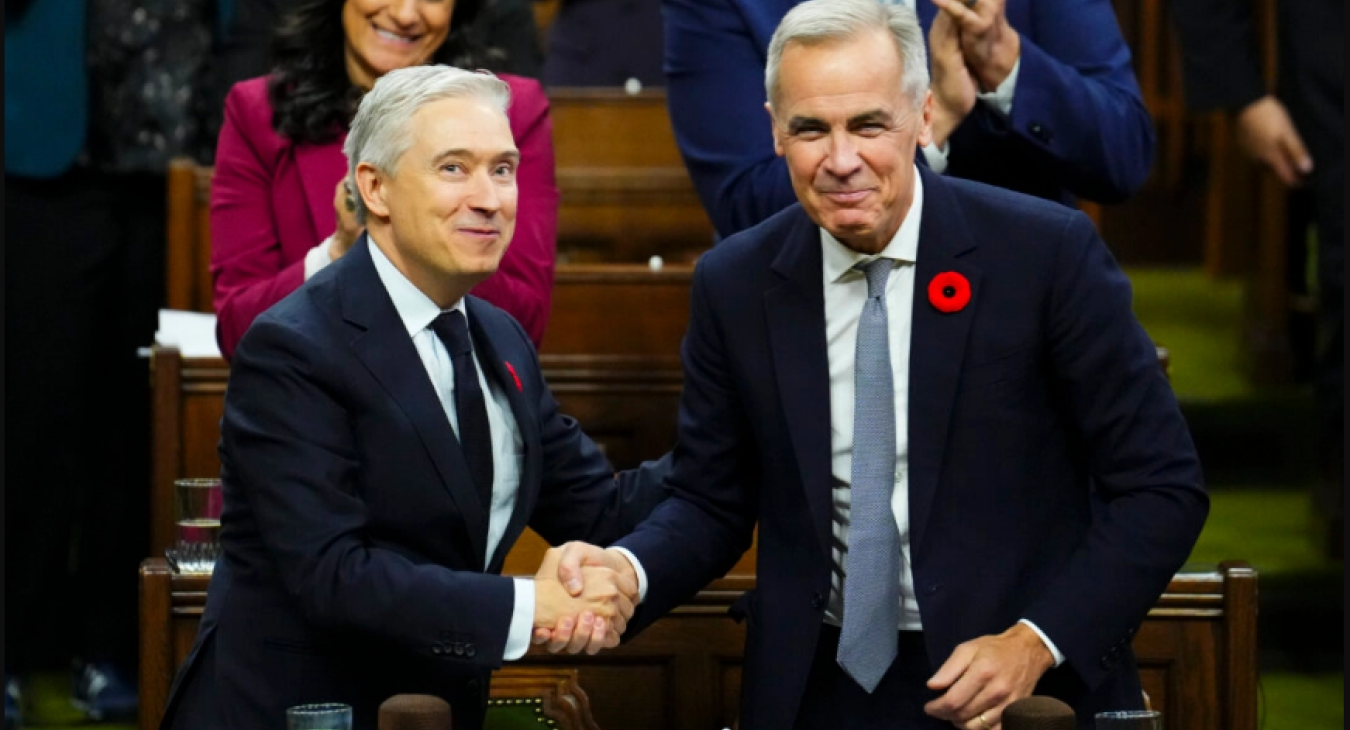 Finance Minister François-Philippe Champagne shakes hands with Prime Minister Mark Carney